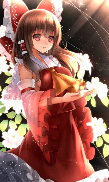 Anime picture 900x1500 with touhou hakurei reimu tsukiriran single long hair tall image blush smile red eyes brown hair bare shoulders traditional clothes dark background miko girl flower (flowers) bow hair bow detached sleeves