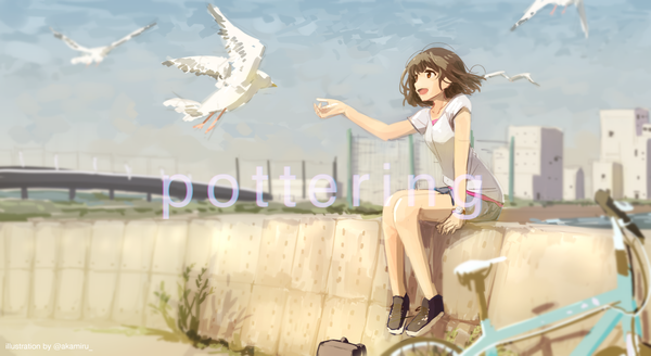 Anime picture 1179x645 with original akame (akamiru) single fringe short hair open mouth smile brown hair wide image sitting brown eyes signed looking away sky bent knee (knees) outdoors blunt bangs profile wind blurry