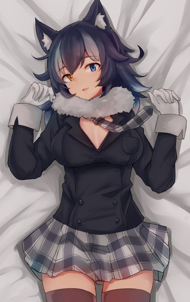 Anime picture 800x1273 with kemono friends grey wolf (kemono friends) nyakonro (nekonro) single tall image fringe blue eyes light erotic black hair hair between eyes animal ears yellow eyes lying grey hair on back zettai ryouiki fur trim heterochromia plaid skirt wolf ears