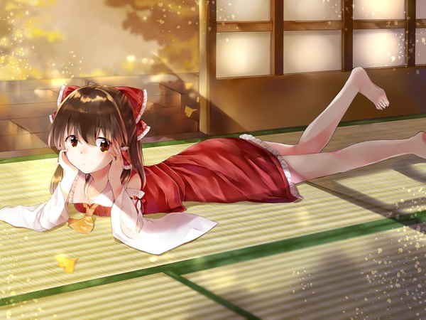 Anime picture 1500x1125 with touhou hakurei reimu yurara (aroma42enola) single long hair fringe hair between eyes brown hair brown eyes looking away indoors lying barefoot shaded face on stomach head rest autumn hands on face girl detached sleeves