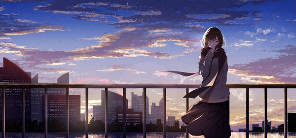 Anime picture 2250x1050 with original kisui single long hair blush fringe highres black hair wide image standing sky cloud (clouds) outdoors eyes closed wind city evening cityscape arm behind back girl