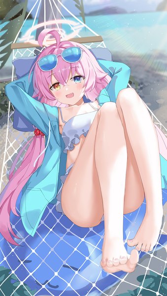 Anime picture 1130x2000 with blue archive hoshino (blue archive) hoshino (swimsuit) (blue archive) serika single long hair tall image looking at viewer fringe light erotic hair between eyes twintails pink hair barefoot bare legs heterochromia low twintails official alternate costume arms behind head sunglasses on head