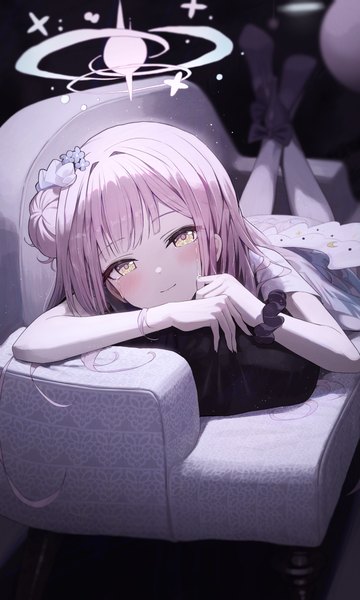 Anime picture 1800x3000 with blue archive mika (blue archive) hidulume single long hair tall image looking at viewer blush fringe highres yellow eyes pink hair lying light smile hair bun (hair buns) on stomach wrist scrunchie girl halo couch