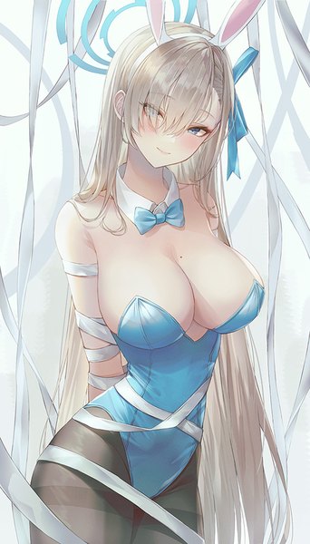 Anime picture 570x1000 with blue archive asuna (blue archive) asuna (bunny) (blue archive) vennie single long hair tall image looking at viewer fringe breasts blue eyes light erotic blonde hair smile large breasts standing animal ears hair over one eye mole bunny ears