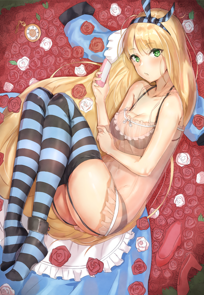 Anime picture 830x1200 with alice in wonderland original alice (alice in wonderland) reinama single long hair tall image looking at viewer blush fringe breasts light erotic blonde hair hair between eyes bare shoulders holding green eyes cleavage full body lying
