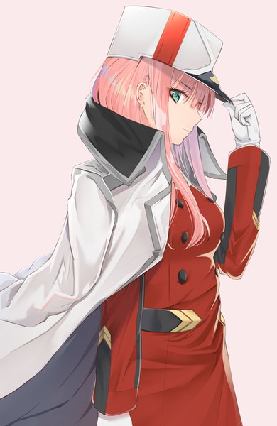 Anime picture 1098x1687 with darling in the franxx studio trigger zero two (darling in the franxx) hikashou single long hair tall image looking at viewer fringe simple background green eyes pink hair upper body blunt bangs profile pink background clothes on shoulders adjusting hat military girl